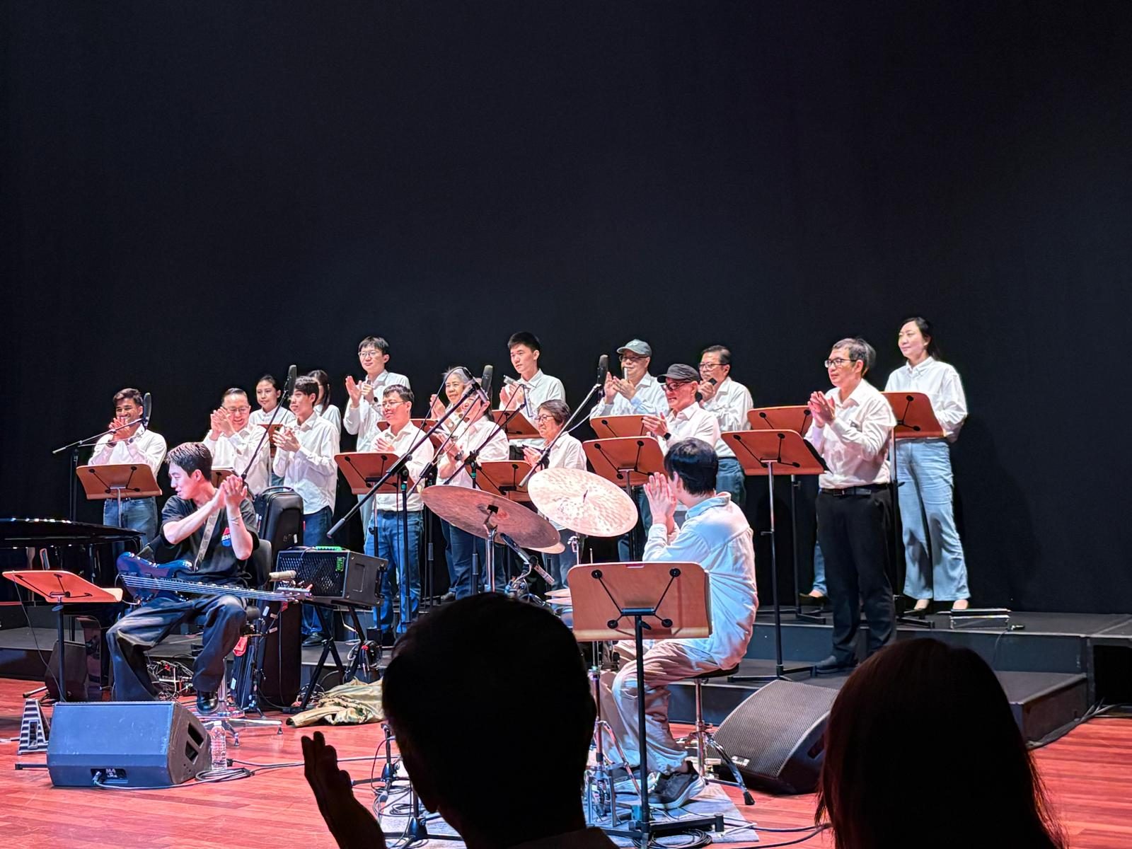 HAS harmonica ensemble taking a bow on stage